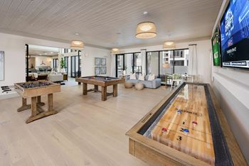 Game room with pool table, shuffleboard and wet bar
